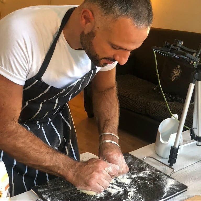 Chef Luca Favorito makes handmade pasta dough on a marble slab